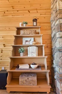 a wooden shelf with books on it next to a wall at Sky High Mountain Lodge Lake View in Big Bear Lake