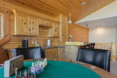 a dining room with a table with chess at Sky High Mountain Lodge Lake View in Big Bear Lake
