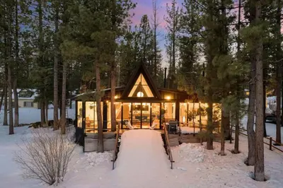 a house in the woods in the snow at Mountain Top Modern Lakefront in Sunset Magazine in Big Bear Lake