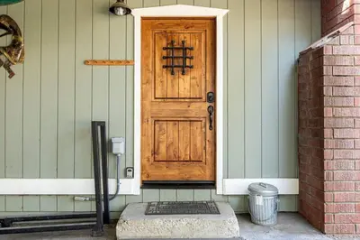 a wooden door on a house with a brick at Snowcrest Lodge in Exclusive Fox Farm in Big Bear Lake