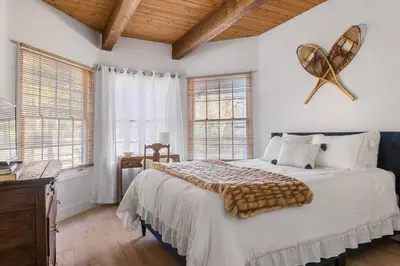 a bedroom with a large bed with a fish on the wall at HoneyBear Lodge Lakefront in Big Bear Lake