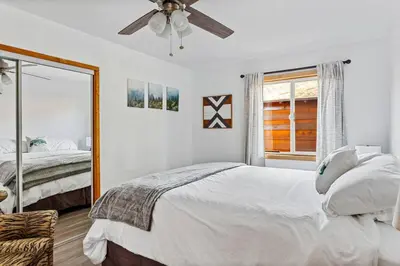 a bedroom with a bed and a ceiling fan at Honeybee by the Bay in Big Bear Lake in Big Bear Lake