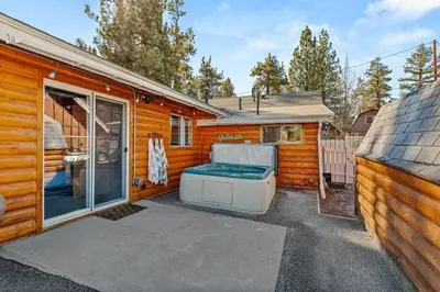 a exterior view of a cabin with a hot tub at Honeybee by the Bay in Big Bear Lake in Big Bear Lake