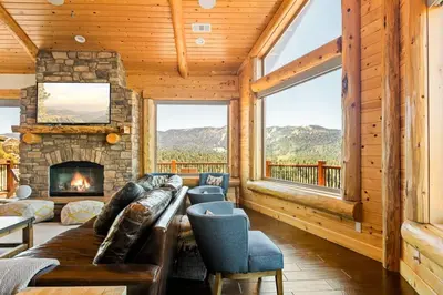 a living room with a couch and a fireplace at Hidden Haven Estate in Big Bear Lake