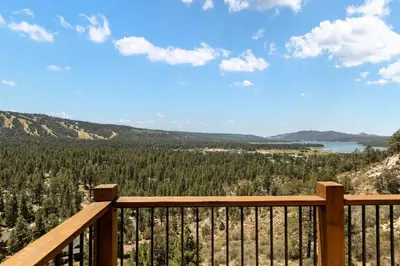 a view from a wooden deck with a view of trees at Hidden Haven Estate in Big Bear Lake