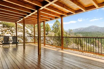 an empty deck with a view of the mountains at Hidden Haven Estate in Big Bear Lake