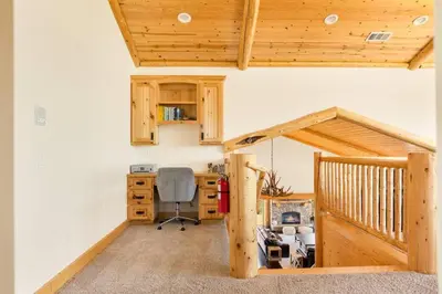 an attic office with a desk and a chair at Hidden Haven Estate in Big Bear Lake
