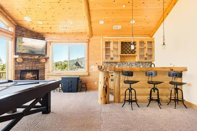 a ping pong table in a room with a pool table at Hidden Haven Estate in Big Bear Lake