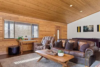 a living room with a couch and a table at Fallen Leaf Hideaway Castle Estate in Big Bear Lake