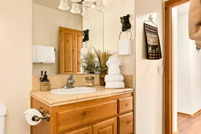 a bathroom with a sink and a mirror at Fallen Leaf Hideaway Castle Estate in Big Bear Lake