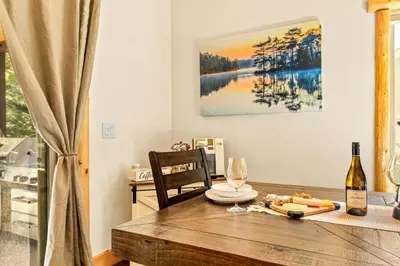 a table with a bottle of wine and a glass at Zen Mountain Retreat in Big Bear Lake