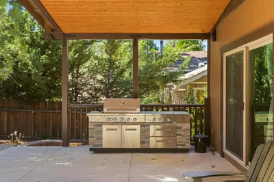 an outdoor kitchen with a stove in a backyard at Zen Mountain Retreat in Big Bear Lake