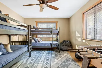 a bedroom with bunk beds and a ceiling fan at The Great Escape in Big Bear Lake