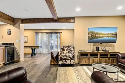 a living room with a flat screen tv and furniture at The Great Escape in Big Bear Lake