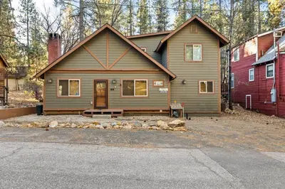 a house with a bench in front of it at The Great Escape in Big Bear Lake