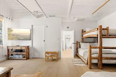 a bedroom with a bunk bed and a desk at Lakefront View Stunner in Big Bear Lake
