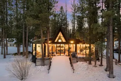 a cabin in the woods in the snow at Lakefront Modern A Frame in Big Bear Lake