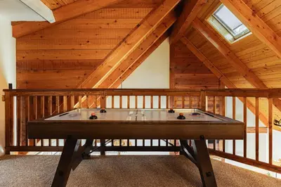 a pool table in a room with a wooden ceiling at Knoll Lake Cabin in Big Bear Lake in Big Bear Lake