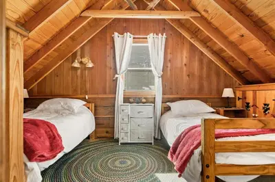 two beds in a room with a attic at Tree Top Ranch in Big Bear Lake