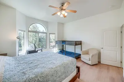 a bedroom with a bed and a ceiling fan at Serene Pine Mountain Club Home with Pool Access! in Pine Mountain Club
