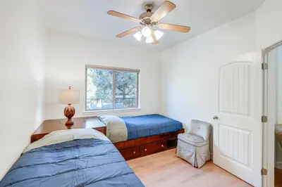 a bedroom with a bed and a ceiling fan at Serene Pine Mountain Club Home with Pool Access! in Pine Mountain Club