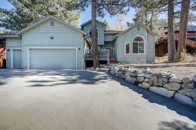 a house with a garage and a driveway at Serene Pine Mountain Club Home with Pool Access! in Pine Mountain Club