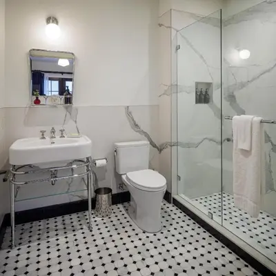 a bathroom with a toilet and a sink and a shower at Hotel San Buena in Ventura