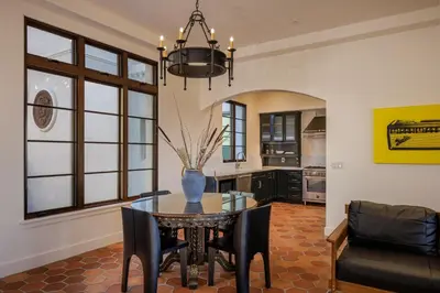 a dining room with a table with a vase on it at Hotel San Buena in Ventura