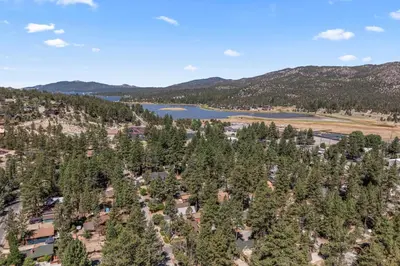 an aerial view of a resort with trees and a lake at The Teddy Bear Cabin! Large Patio! in Big Bear City