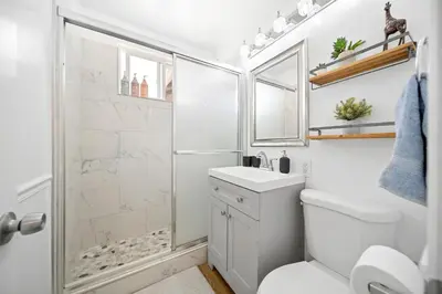 a bathroom with a shower and a toilet and a sink at Spacious 3Bdr Home close to Manhattan Beach in Lawndale