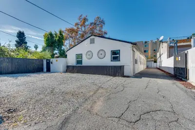 a white building with two clocks on the side of it at Van Nuys Abode with Patio, 7 Mi to Universal Studios in Van Nuys