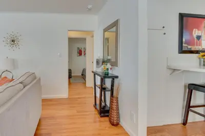 a living room with a couch and a mirror at North Hollywood Getaway 14 Mi to Downtown! in North Hollywood