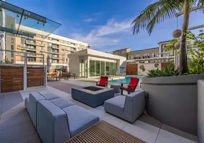 a patio with furniture and a swimming pool at @ Marbella Lane - Grand 2BR w/ Beach & Ocean Views in Long Beach