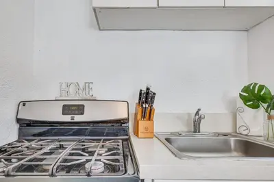 a kitchen with a stove top oven next to a sink at Los Angeles Apartment with Patio, 4 Mi to Downtown! in Los Angeles