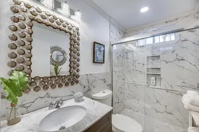 a white bathroom with a sink and a mirror at Los Angeles Apartment with Patio, 4 Mi to Downtown! in Los Angeles