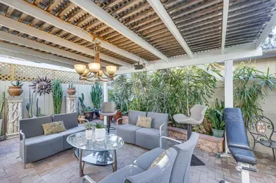 a patio with blue chairs and a table at Los Angeles Apartment with Patio, 4 Mi to Downtown! in Los Angeles