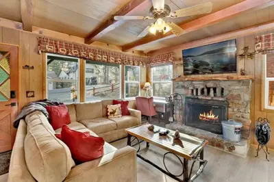 a living room with a couch and a fireplace at Kozy Cabin Big Bear~ Walk to Village & Lake Cottage~ in Big Bear Lake