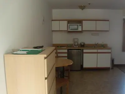 a small kitchen with a counter and a counter top at Corral Creek Lodge in Kernville