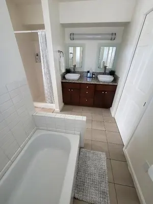 a bathroom with two sinks and a bath tub at 4 Bedrooms & 2.5 Bathrooms in LA in Los Angeles