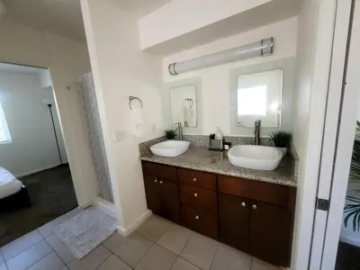 a bathroom with two sinks and two mirrors at 4 Bedrooms & 2.5 Bathrooms in LA in Los Angeles