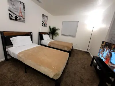 a hotel room with two beds and a lamp at 4 Bedrooms & 2.5 Bathrooms in LA in Los Angeles