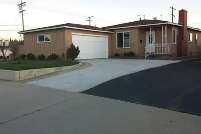 a driveway in front of a house with a garage at Family getaway 3 BR 2 Bath home in Lomita, CA. in Los Angeles