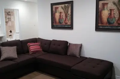 a brown couch in a living room with two pictures at Family getaway 3 BR 2 Bath home in Lomita, CA. in Los Angeles