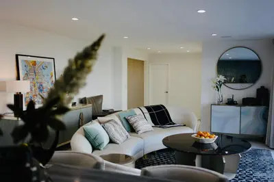 a living room with a white couch and a table at Skyline Serenity Luxe Suite-Private Room in Los Angeles