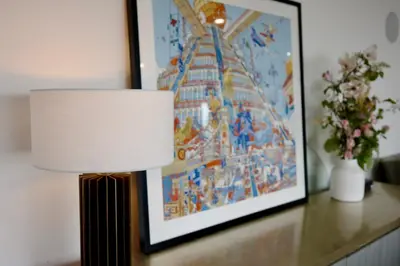 a lamp sitting on a table next to a painting at Skyline Serenity Luxe Suite-Private Room in Los Angeles