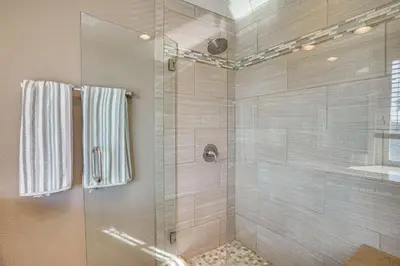 a bathroom with a shower with a glass door at Huntington Beach Condo - Walk to the Ocean! in Huntington Beach