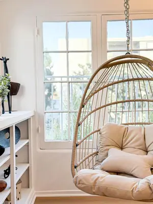 a rattan swing in a room with a window at Modern 2-Bedroom Gem Close to Beverly Hills - DOH2 in Los Angeles