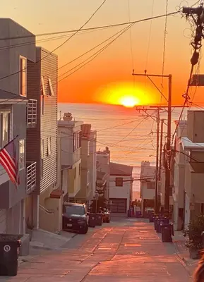 a city street with a sunset in the background at Beach Gateway Full Kitchen 1 Bedroom Duplex in Manhattan Beach