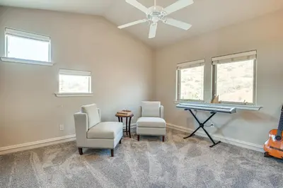a living room with two chairs and a piano at Expansive Mountain Gem Game Room, 3 Mi to Acton in Ravenna
