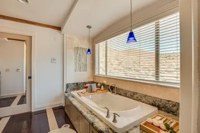a bathroom with a large tub and a window at Expansive Mountain Gem Game Room, 3 Mi to Acton in Ravenna